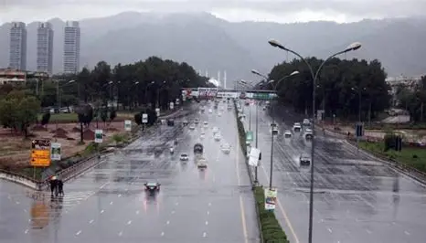 Rain in Islamabad – cars driving on a wet road with Margalla Hills in the background during monsoon season