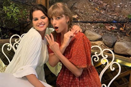 Taylor Swift and Selena Gomez smiling and posing together at an outdoor table, showing their close friendship.