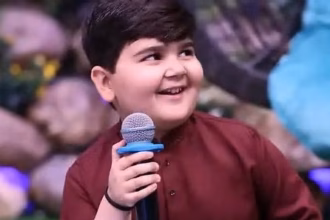 Alt text: “Umar Shah, younger brother of Ahmad Shah, holding a mic during Shan-e-Ramzan transmission”